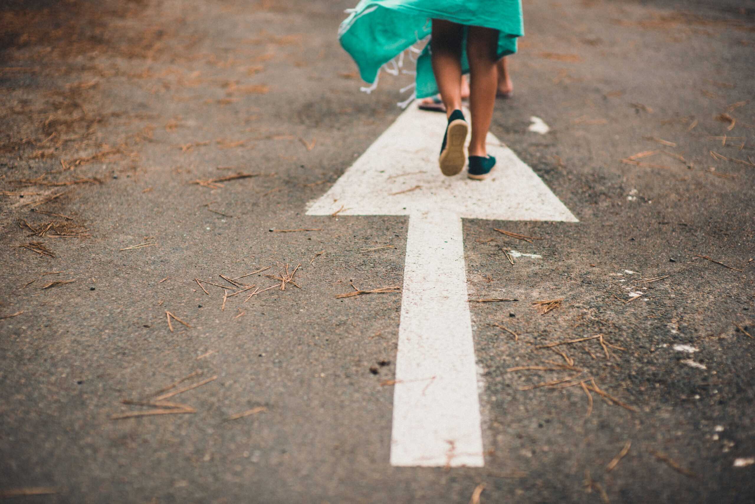child walking on arrow street